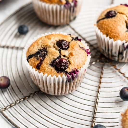 healthy blueberry oatmeal muffins on a round wire rack